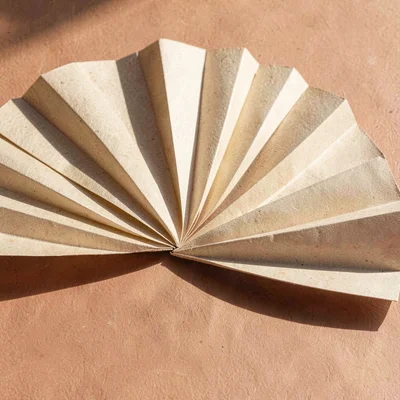 Vector fan of paper-like wedges spreading horizontally, sun-baked terracotta and