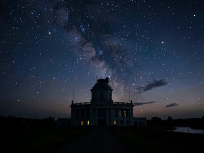 First stars appearing behind observatory silhouette