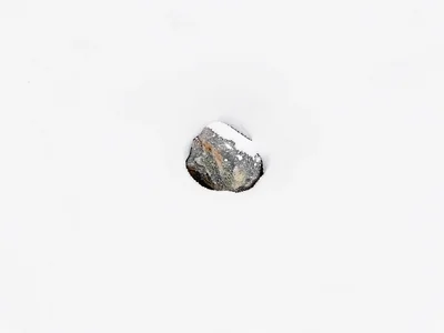 Single stone emerging from snow drift