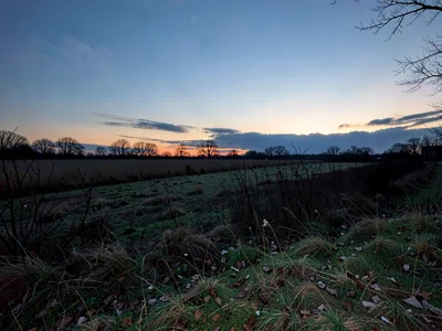 Field at dusk showing remaining sky glow