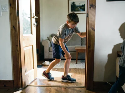 Teenager sneaking in past curfew, caught in the act of crossing the threshold, o