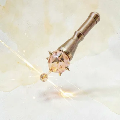 Solid citrine lowpoly mace with a spiked faceted ball head dropping golden caust