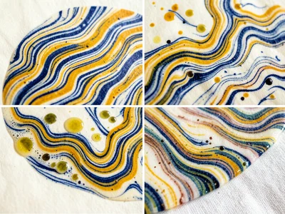 Combed tarakli ebru pattern, parallel wavy lines of indigo and ochre yellow rake