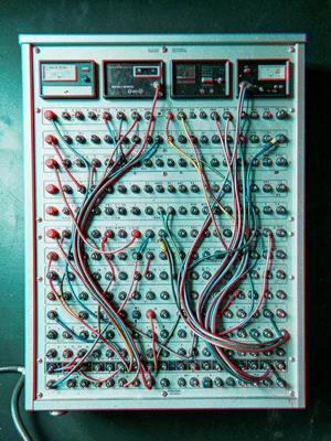 An old telephone switchboard with its rows of jacks, cables, and patch leads — d