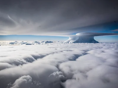 Storm anvil spreading at altitude showing smooth glaciated texture