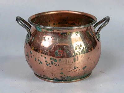 Copper pot showing hammer marks and patina