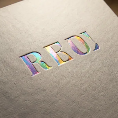 Holographic foil emboss detail, rainbow diffraction pattern following the stampe
