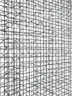 Woven wire diploma scroll, fine construction, shadow on white wall