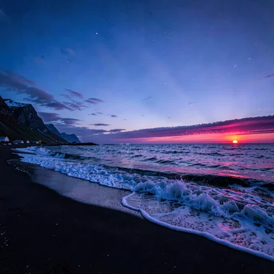 Polar liminal light, extended blue hours, Waves crashing on black sand beach in 