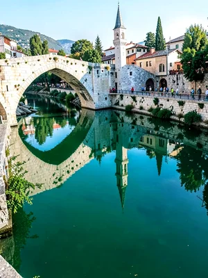 Mosque minaret reflected in Neretva