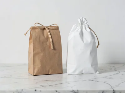 Kraft paper bags with twine on light wood