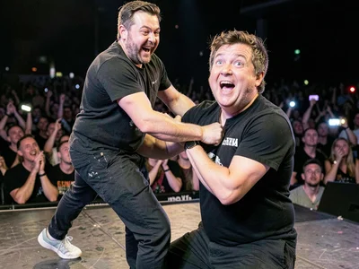 Person at concert being pulled on stage, moment of surprised selection