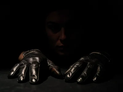 Leather gloves on dark surface