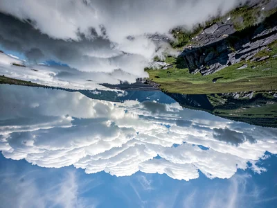 Cloud formation resembling landscape inverted in sky