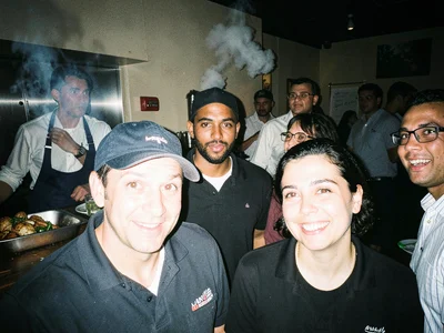 Kitchen staff smoking behind restaurant