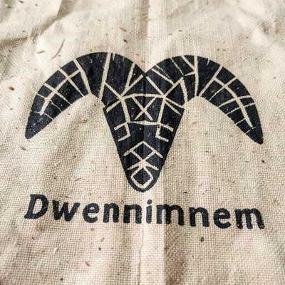 Dwennimmen symbol detail — ram's horn form in black dye on natural woven cloth
