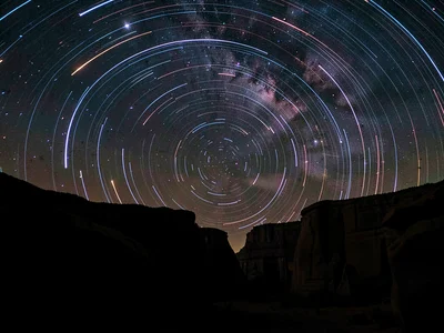 Trails over canyon walls dark silhouette