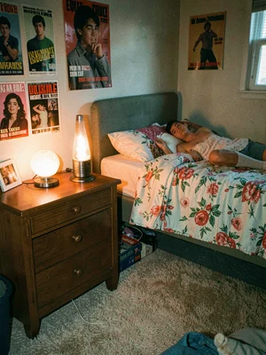 Lava lamp glowing on nightstand, teen bedroom posters, shag carpet, 1976 accurat