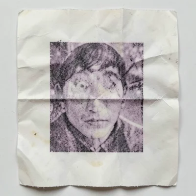 Crumpled receipt paper smoothed out, thermal print distorted by the wrinkle line