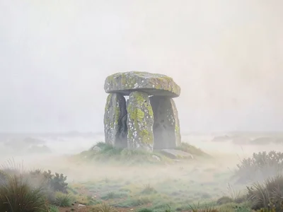 Capstone dolmen squatting on a moor, lichen-spotted, surrounding ground turning