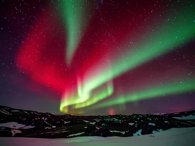 A rare red aurora over Iceland, the unusual deep crimson glow covering the upper