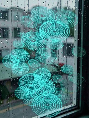 Rain on window visualized as thousands of tiny cyan impact rings