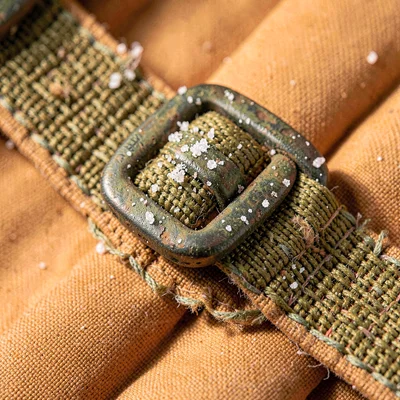 Macro of a life vest buckle with salt patina and webbing fray