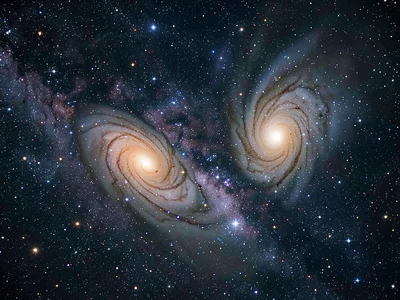 A two-galaxy interaction — two spiral galaxies distorting each other with tidal 