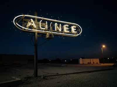 A diner sign mounted on a steel pole above a flat roof, a horizontal oval of ben