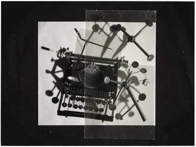 A collection of typewriter parts — keys, springs, arms — as overlapping photogra
