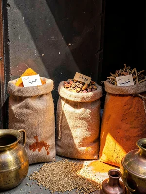 Three Burlap Spice Sacks Against Dark Wall