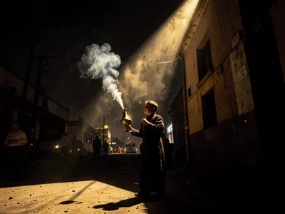 Dramatic light through darkness in Addis Ababa, Ethiopia, Child acolyte carrying