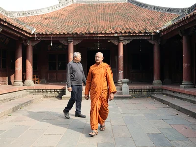 Monk walking courtyard