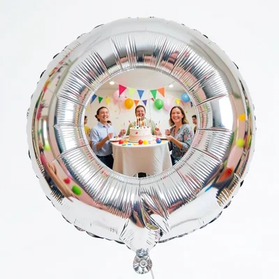 Silver helium balloon reflecting birthday party in its convex surface, joy curve