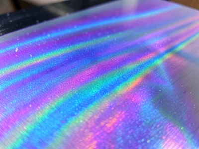 Anodized titanium surface, controlled oxide thickness creating vivid purple-blue