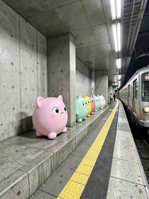 Sumikko Gurashi lineup on metro platform edge, yellow safety line, waiting for t