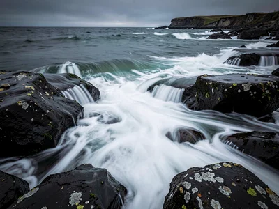Crashing waves rendered silk-smooth over dark granite