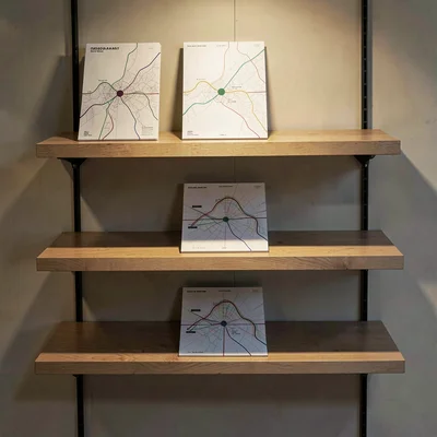 Tiered shelf display of three abstract roadmap mockups stepping back into depth,