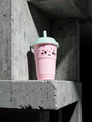 Pink bubble tea on brutalist building ledge, board-formed concrete texture, star