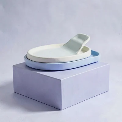 Catalog ad of a pastel set on a periwinkle block, hairline shadow