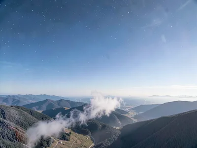Frost smoke rising from valley into thin clear atmosphere