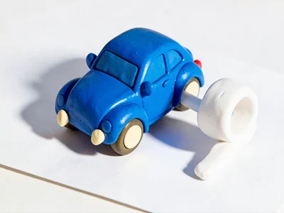 Snazzy chunky clay car key with primary-blue body, stubby cream-toned teeth and