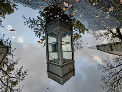 Phone booth reflected in puddle