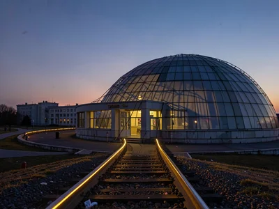 Dome track rails catching low sun as golden lines