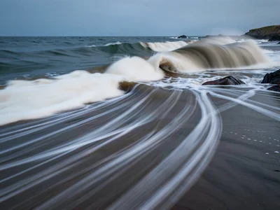 Wave surge leaving trails of dissolved motion