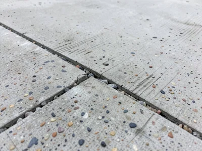 Expansion joint in concrete slab, deliberate crack with sealant, geometric line 