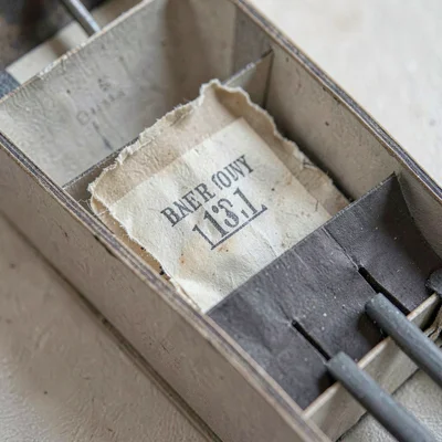 Paper close-up of a brittle aged repair label glued inside an instrument body