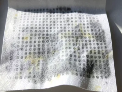 Thermal paper in direct sunlight, entire surface darkening to grey, UV-accelerat