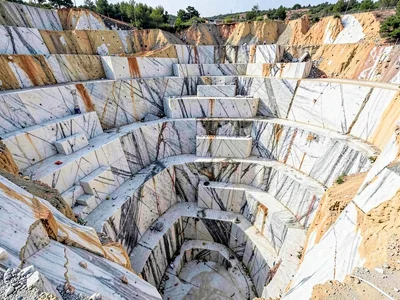 Quarry viewed from below showing massive scale of cuts