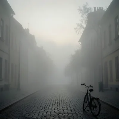 A cobblestone street receding into fog, the buildings on either side becoming si